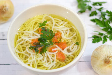Tasty chicken broth with noodles and vegetables