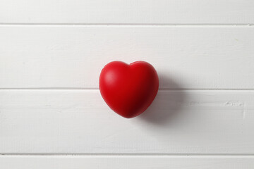 Red heart on wooden background
