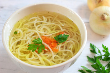 Tasty chicken broth with noodles and vegetables