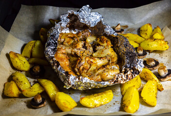Potato with meat frying in the oven. Home food preparing.
