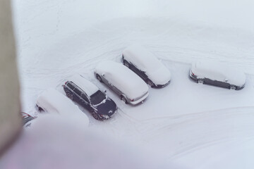 Top view of parking lot with cars under snow at backyard of residential house. © Bonsales