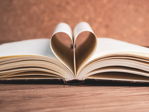 pages of a book curved into a heart shape