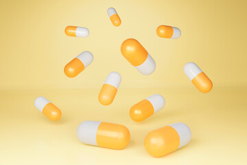 Capsules, drugs, floating on yellow background.
