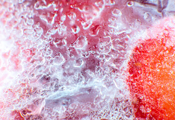 Frozen strawberries texture. Close up. Cold fruit in snow.