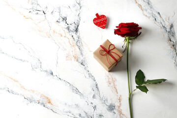 Red roses and gift box on a textured background. Love confession. Valentine's day celebration