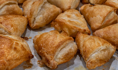Burekas with cheese on Tel Aviv bakery display. Selective focus.