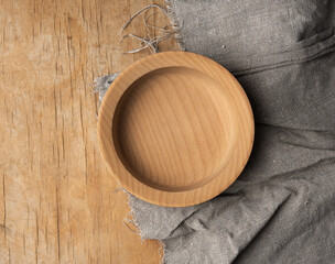 empty round brown wooden plate on table