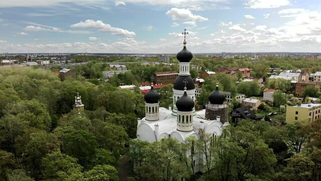 Aerial orbit shot of beautiful old orthodox church of St. John the Forerunner in Riga with dome on reconstruction