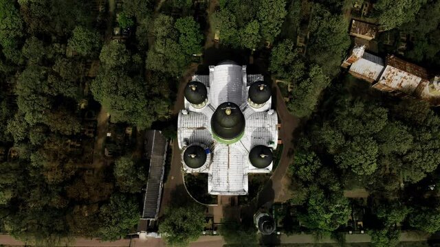 Aerial moving top to front shot of old orthodox church of St. John the Forerunner in Riga with dome on reconstruction