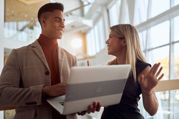 Two colleagues talking about job tasks at company's hallway. People, job, company, business concept.