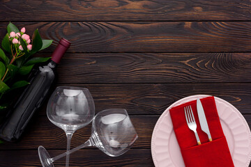 Valentine's day table setting with plate, wine and glasses