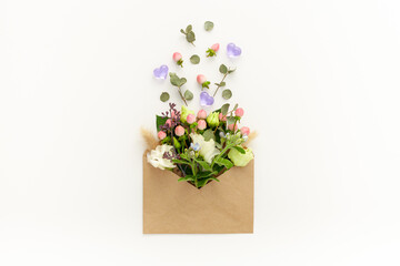Composition with craft envelope and delicate flowers