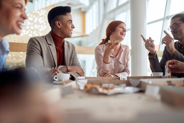 A group of employees having a good time at a break at company's canteen. People, job, company,...
