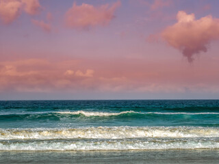 Waves lap at dawn on the beach in Tarifa, Spain