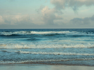 Waves lap at dawn on the beach in Tarifa, Spain