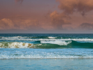 Waves lap at dawn on the beach in Tarifa, Spain