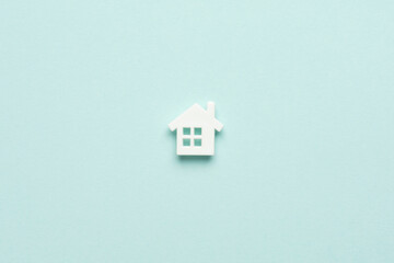 Fototapeta na wymiar Miniature house on light blue mentol background. Top view. Buy of property, home, real estate. affordable housing. advantageous offer from the bank.