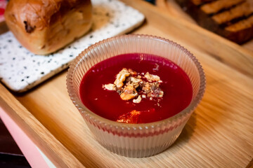liver mousse with cranberry jelly and walnuts. poultry liver pate with cranberry sauce and walnuts served in a glass bowl. liver pate with walnuts and cranberry topping  
