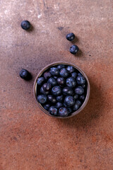 blueberries in a bowl on table, healhty food,  fresh blueberry on dark stone background
