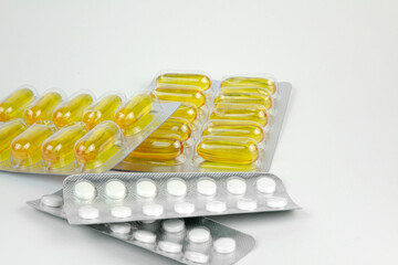 Pills in transparent packaging on a white background