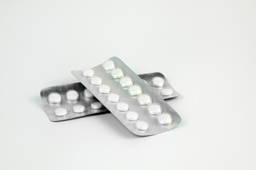 Pills in transparent packaging on a white background