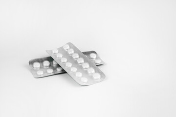 Pills in transparent packaging on a white background