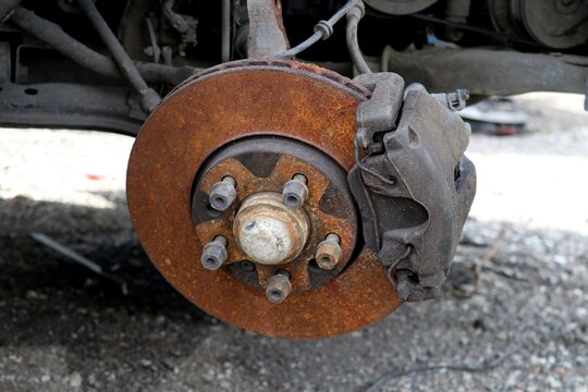 Old rusty break disc on the car