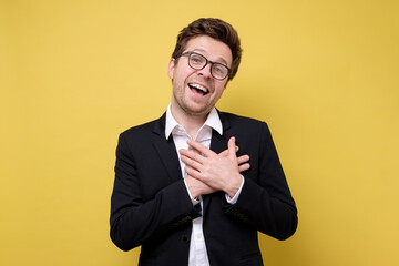 Happy caucasian man in suit being content to hear compliment