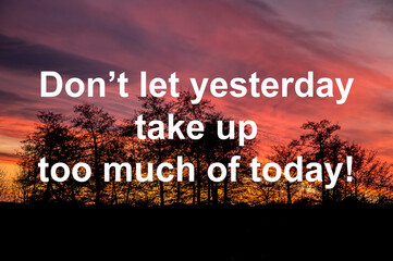 Inspirational motivational quote Don’t let yesterday take up too much of today on  sunset background.