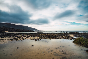 Rocky coast of northern Lanzarote at low tide on a cloudy day