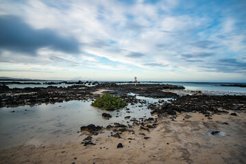 Rocky coast of northern Lanzarote at low tide on a cloudy day