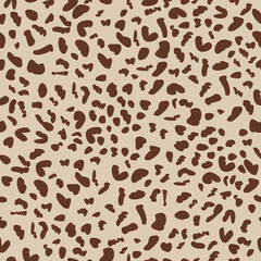 Brown spots on beige background. Cheetah seamless pattern. Repeating pattern.