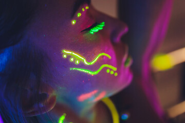 beautiful girl with lsd on tongue in nightclub with pink smoke.