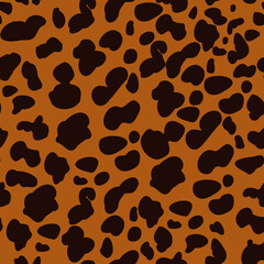 Brown cheetah spots on orange background. Animal seamless pattern. Repeating pattern.