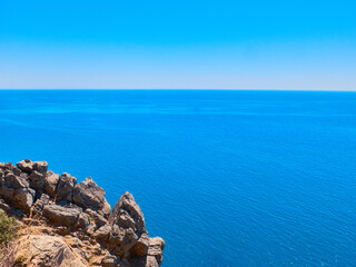 Sheer cliff above the sea. Sea and sky landscape with copy space