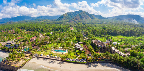 An aerial panoramic image of Candidasa shoreline on Bali island in Indonesia