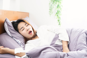 Asian woman snoring and open mouth while sleeping in bed