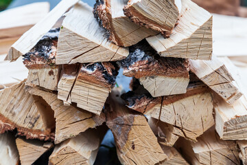 A stack of firewood from a birch tree for igniting a fire in the bath or fireplace