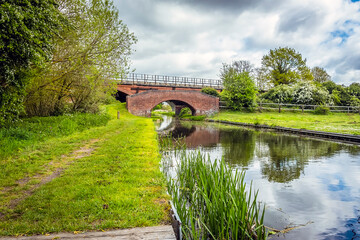 A view along the Chesterfield canal towards the Manton railway viaduct and the canal bridge in Nottinghamshire, UK in springtime