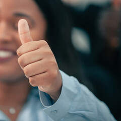 close up. young businesswoman giving a thumbs up.