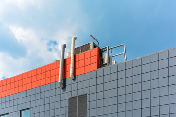 exhaust ventilation pipes and air conditioners are located on the roof of the production building