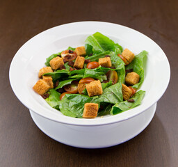 Vegetable salad topped with white bowl of fiber bread