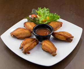 Fried chicken wings in white plate