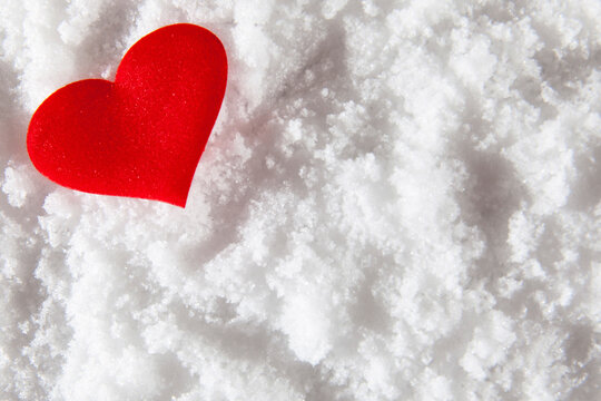 Red heart in the snow. Valentine's day greeting card