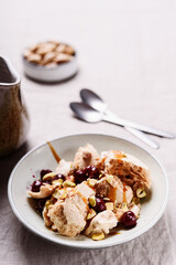 Not traditional Eton mess. Meringue, pistachio, cherry and caramel sauce dessert. Selective focus