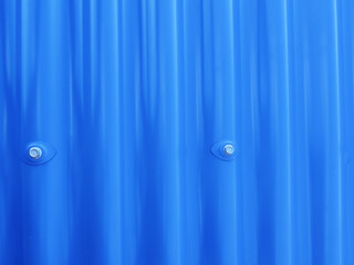 Blueish metallic corrugated sheet roof texture. Deep blue profiled sheet panel. Corrugated Metal Roof Exterior Close up.