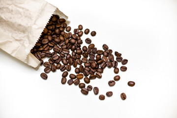 Coffee beans in paper package. White background.