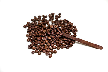 Coffee beans in wooden spoon. White background.