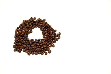 Coffee beans with hollow heart-shaped space. White background.