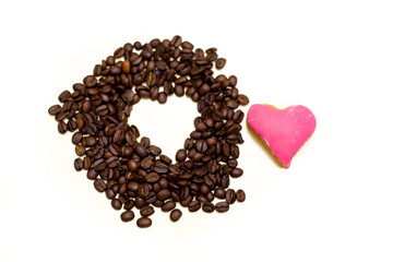 Coffee beans with hollow heart-shaped space. White background.